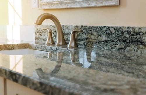 Kitchen countertop with a renewed stone-look resurfaced finish by The Horses Construction Services